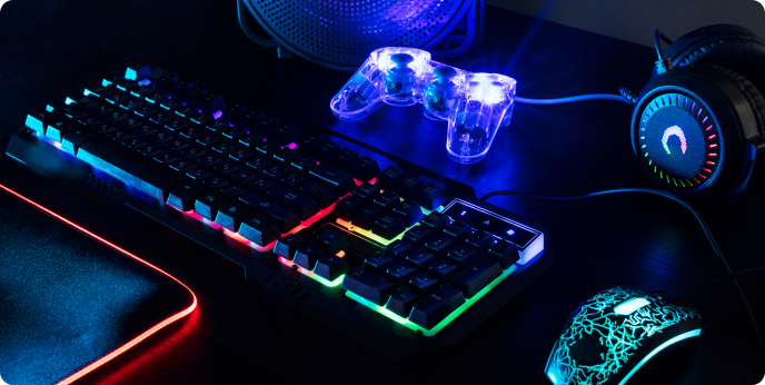 laptop, gamepad and keyboard on the table